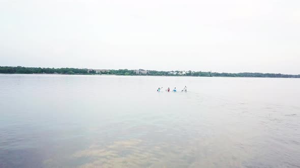 Well-coordinated Team Kayaking on Lake