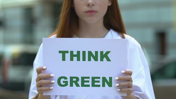 Think Green Sign in Female Hands, Eco Volunteering, Environmental Protection alt