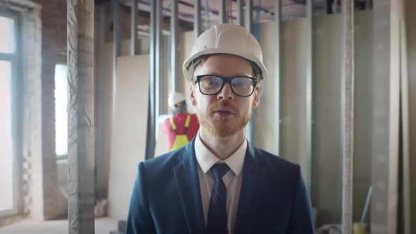 Foreman Talking Via Video Chat with Owner on Construction Site alt