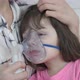 A kid in a mask nebulizer.