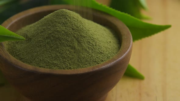 Green tea powder in wood bowl