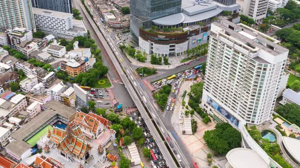 Bangkok business district city center above intersection and traffic, during night - Time Lapse