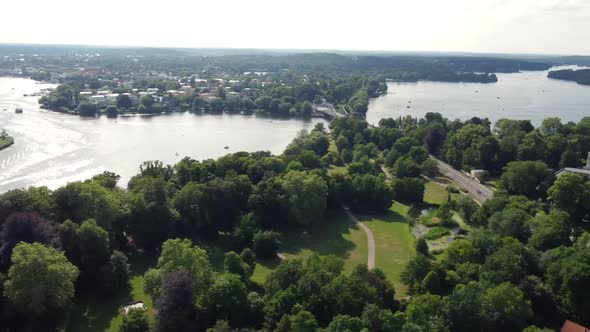 Smooth aerial flight panorama over view drone shot of perfect luxury villa in park on a river forest alt