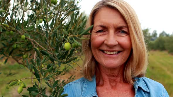 Portrait of happy woman standing in olive farm 4k alt