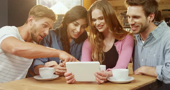 Group of friends using digital tablet  alt