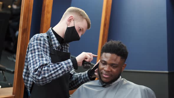 Young Africanamerican Man Visiting Barbershop for Haircut alt