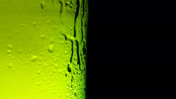 Water Drops Falling Down on the Glass of Beer