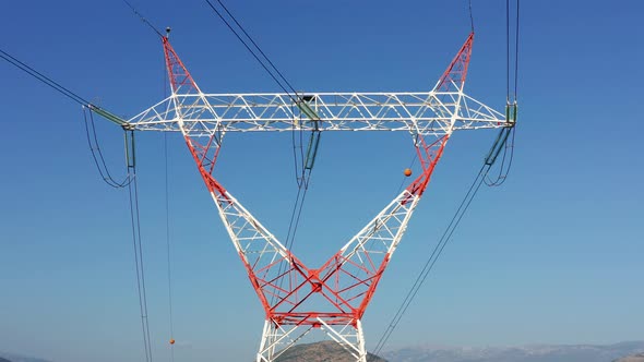Transmission tower supporting an overhead high voltage power line (wires)