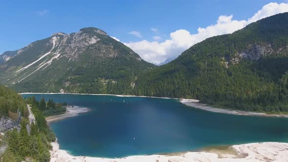 Aerial View of Lake Predil with Turquoise Water and Mountains in Background, Alps, Italy alt