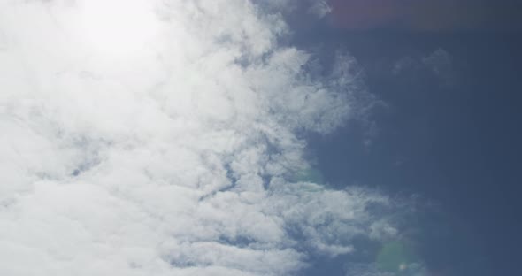 Low angle of blue sky with sunshine and clouds alt