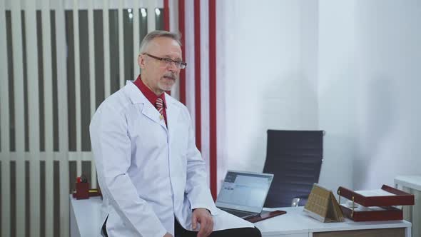 Doctor is working in his medical office alt