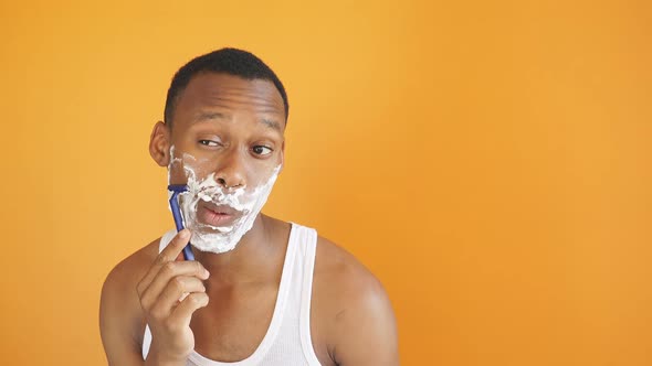 Young African American Man Shaving Foam His Face Doing Morning Routine alt