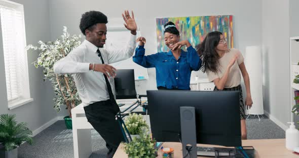 Dance at Work Office Break From Duties Company Party Two Girls and a Man in a Shirt and Tie Dancing alt