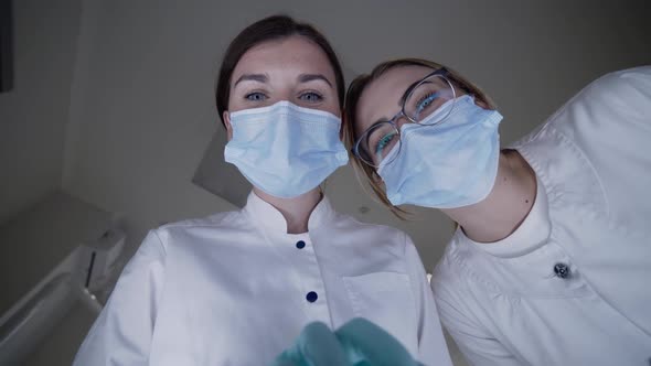 POV Shot of Patient Seeing Female Dentist with Assistant During Treat Procrdure alt