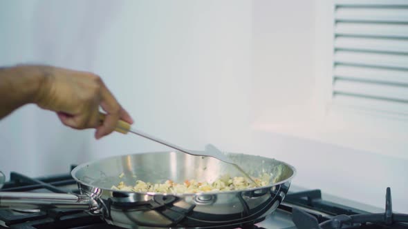 Indian Chef Hand Mixing Ingredients In Pan