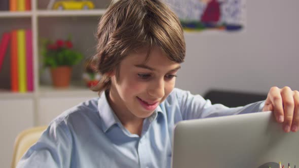 Portrait of Student Boy Opening Laptop Computer alt
