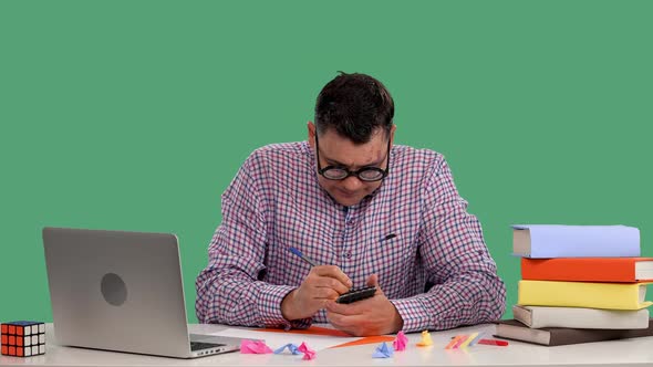 A Man Sits at a Desk Thinks About Something Makes Notes in a Notebook Tears Out a Sheet Sticks a alt