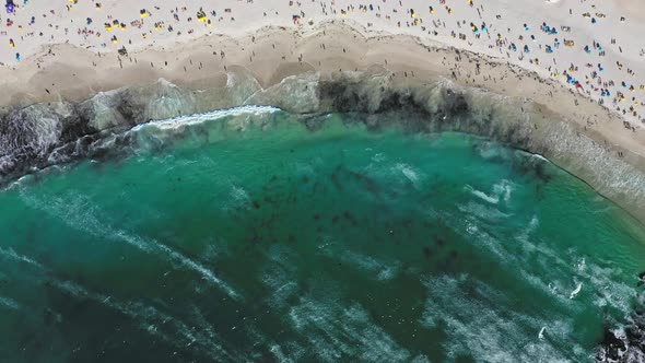 High angle view looking down on a very packed Camps Bay beach