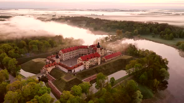 Amazing Dawn in the Foggy Nesvizh, Fog Over the River. Nesvizh. Ancient Castle . Belarus alt
