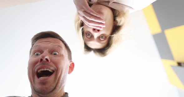 Surprised Young Customers Looking Inside Cardboard Box alt