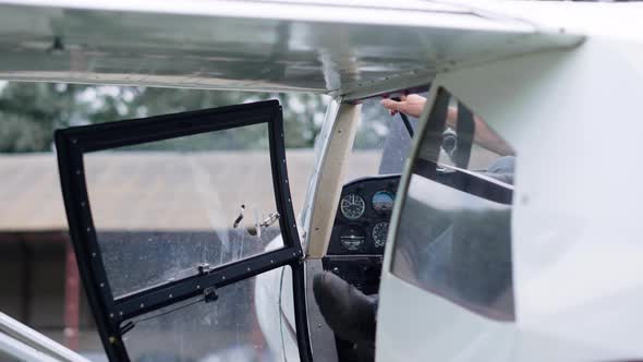 Aviator Exiting Cabin Airplane on Aerodrome alt