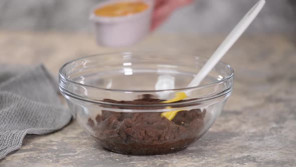 Preparing Chocolate Choux Dough in Bowl, Adding Eggs To the Dough alt