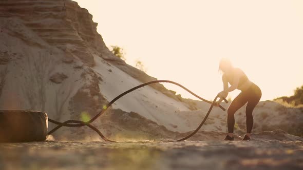 Female Athlete Training Outdoors Around the Sand Hills at Sunset alt
