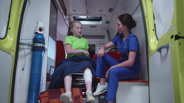 Nurse and Sick Girl in Ambulance Car. alt