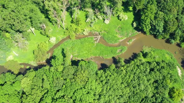 Aerial view of a river flowing through a beautiful landscape  alt