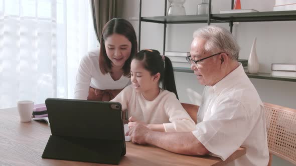 Family helping children to study at home during virtual classes. alt