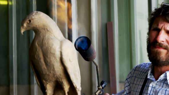 Craftsman preparing bird sculpture 4k alt