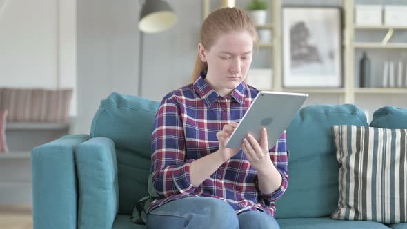 Young Woman Using Tablet Computer for Internet alt