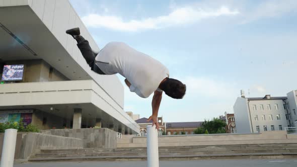Athletic Man Jump Somersaults in an Urban Setting Backdrop Beautiful Building alt
