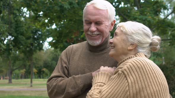 Adult Couple Enjoying Life Hugging in Autumn Park, Love and Devotion, Slow-Mo