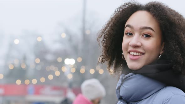 Closeup Portrait African American Curly Beautiful Young Woman Looks at City Standing in Profile Side alt