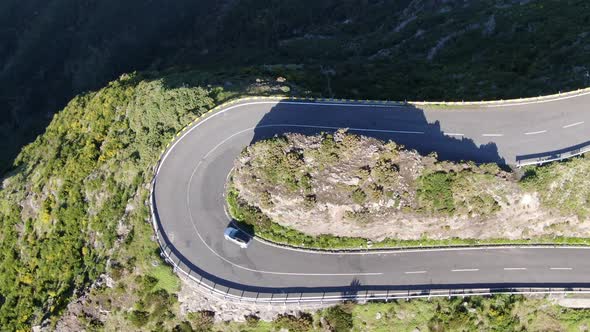 Aerial view of a car driving on a serpentine mountain road, Madeira, Portugal alt