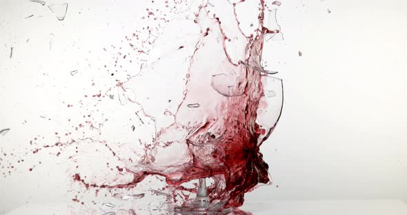 900124 Glass of Red Wine Breaking and Splashing against White Background, Slow motion 4K alt