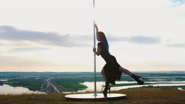 Pole Dance on Nature - Sexy Woman with Long Blue Braids in Black Clothes Dancing on High Heels alt