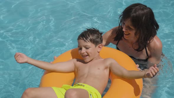 Caucasian Mom and Boy Playing in a Swimming pool, Happy moments, Slow motion alt