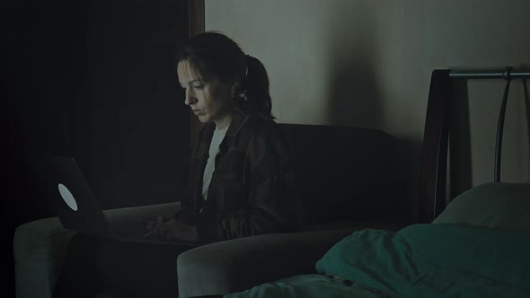 Woman With Laptop In Her Bedroom. alt