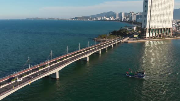 Shooting Aerial Unmanned Flight From Top View of the City Bridge with Cars and Motorbikes Against alt