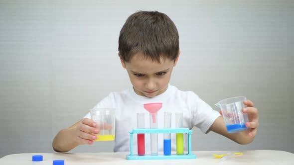 A Happy Child Plays with Chemical Experiments alt