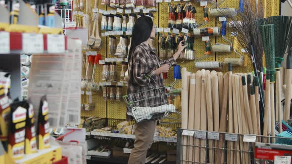Woman Shopping for Supplies at Hardware Store alt