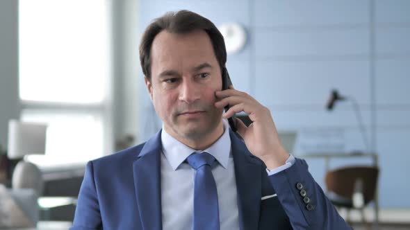 Businessman Negotiating with Customer During Phone Talk alt