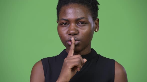 Young Beautiful African Businesswoman with Finger on Lips