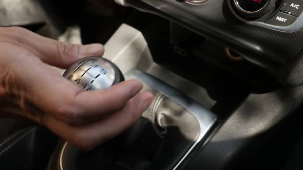 Shifting gears in car with hand slow-mo footage alt