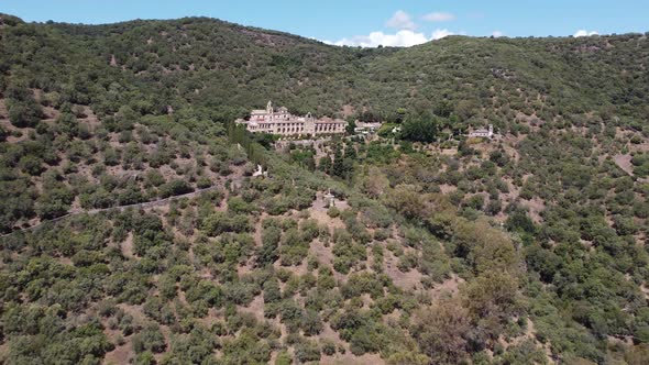Drone view of Old Monastery surrounded by mountains and native Mediterranean vegetation