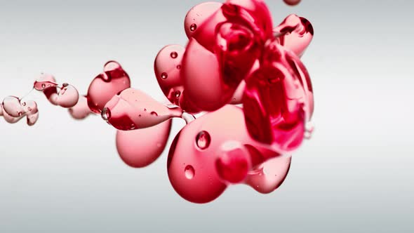 transparent cosmetic red oil bubbles and shapes on white background