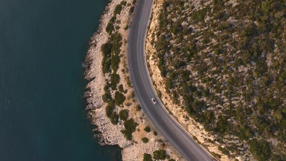 Aerial Drone View of Road Going Along the Mountains and Ocean or Sea alt