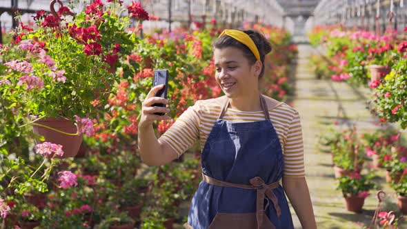 Florist Shoots Video with Smartphone Walking Past Flowers